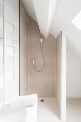 a shower with a shower head in a bathroom at Stylish Duplex for 8 in Central Antwerp in Antwerp