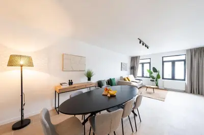 a living room with a table and chairs at Stylish Duplex for 8 in Central Antwerp in Antwerp