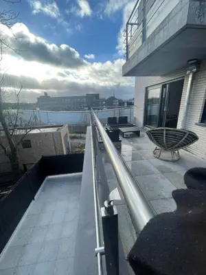 a balcony of a building with a view of the water at Splendide appartement neuf à Zaventem airport in Zaventem