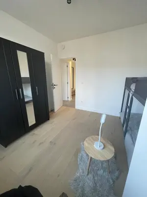an empty room with a table and a staircase at Splendide appartement neuf à Zaventem airport in Zaventem