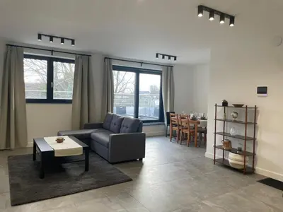 a living room with a couch and a table at Splendide appartement neuf à Zaventem airport in Zaventem