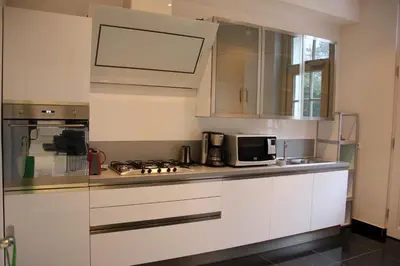 a kitchen with white cabinets and a microwave at Luxury Apartments Arendshof in Antwerp