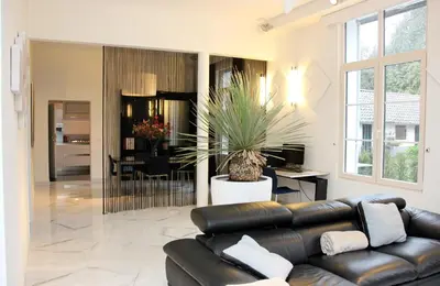 a living room with a leather couch and a table at Luxury Apartments Arendshof in Antwerp