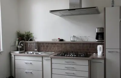 a kitchen with a sink and a stove at Luxury Apartments Arendshof in Antwerp