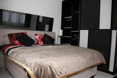 a bedroom with a bed with black and red pillows at Luxury Apartments Arendshof in Antwerp