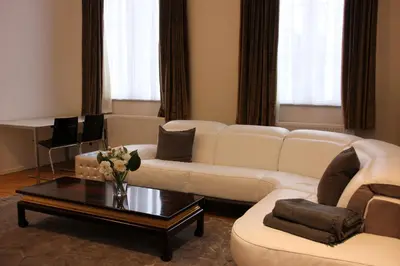 a living room with a white couch and a coffee table at Luxury Apartments Arendshof in Antwerp