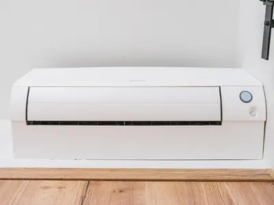 a white computer printer sitting on a floor at Sheela Farm in Rumst