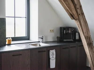 a kitchen counter with a sink and a window at Sheela Farm in Rumst