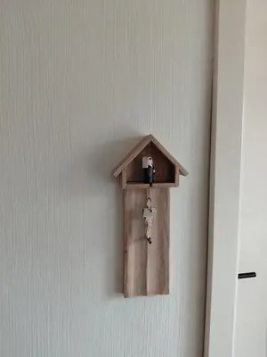a bird house on a wall with a key at Begijnhofpoort B&B in Turnhout