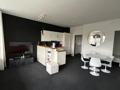 a kitchen with a table and a table and chairs at Charmant appartement in Antwerpen Zuid met zicht op de stroom in Antwerp