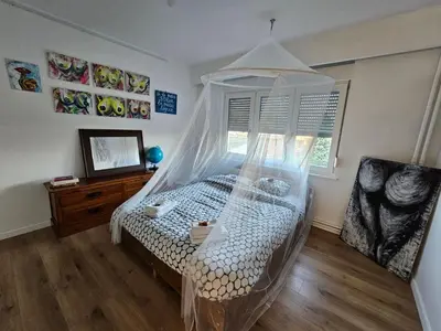a bedroom with a bed with a canopy at Studio El - Cozy Bright Flat in the Green Corner of Antwerp in Antwerp