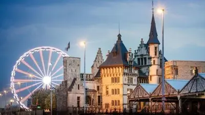 a large castle with a ferris wheel in front of it at Studio El - Cozy Bright Flat in the Green Corner of Antwerp in Antwerp