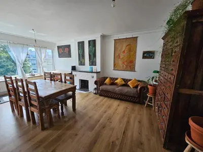 a living room with a table and a couch at Studio El - Cozy Bright Flat in the Green Corner of Antwerp in Antwerp