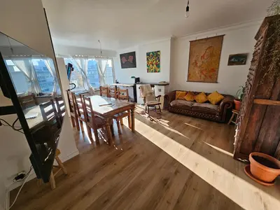 a living room with a table and a couch at Studio El - Cozy Bright Flat in the Green Corner of Antwerp in Antwerp
