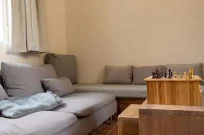 a living room with two couches and a table at Begijnhofpoort Vakantiehuis in Turnhout