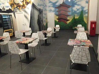 a row of tables and chairs in a room at Midi 81 HOSTEL in Brussels