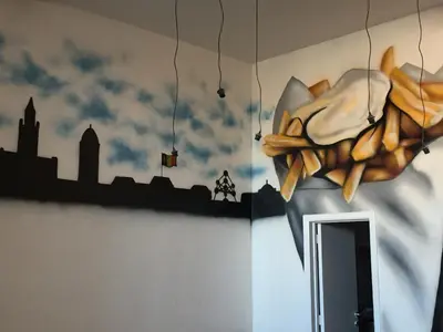 a mural of a city on the wall of a room at Midi 81 HOSTEL in Brussels