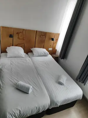 a bedroom with two beds with pillows and a window at Midi 81 HOSTEL in Brussels