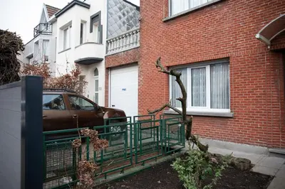 a car parked in front of a brick building at Cozy family home near LottoArena Antwerpen in Antwerp