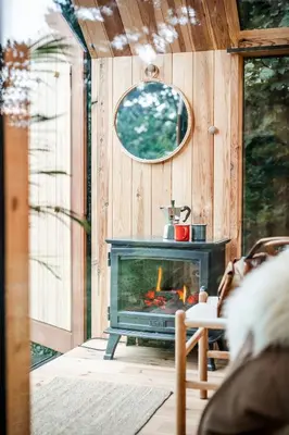 a living room with a fireplace in a house at Sterrenhuisje aan de Beddermolen in Westerlo