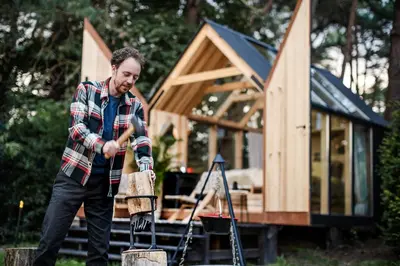 a man standing in front of a tiny house at Sterrenhuisje aan de Beddermolen in Westerlo