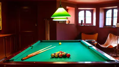 a pool table with cue balls and chopsticks on it at Guest house La Maison Chantecler in Brussels