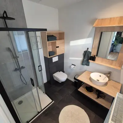a bathroom with a shower and a toilet and a sink at Orient Herent - Boetiekhotel in Herent