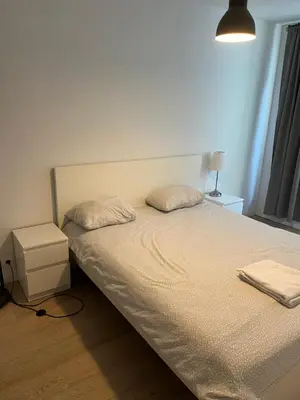 a bed with two pillows on it in a bedroom at Brussels European flat in Brussels