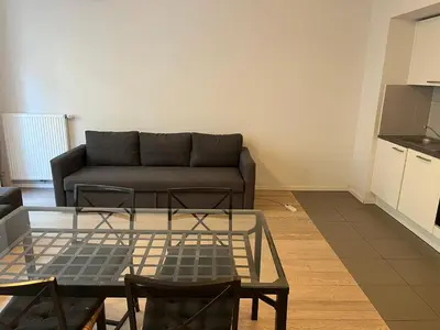 a living room with a couch and a table at Brussels European flat in Brussels