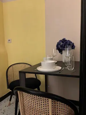 a table with a plate and wine glasses on it at Your Haven of Peace! in Brussels