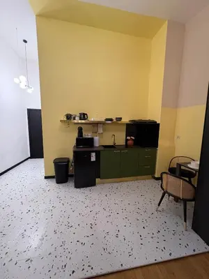 an empty room with green cabinets and a kitchen at Your Haven of Peace! in Brussels