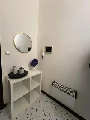 a bathroom with a mirror on a white wall at Your Haven of Peace! in Brussels