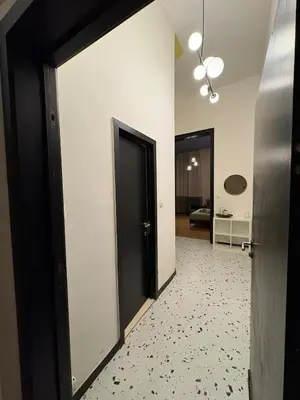 a hallway with a black door and a room at Your Haven of Peace! in Brussels