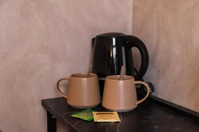 two cups sitting on a table with a coffee pot at 3 Stylish Studios at a Great Location in Gent in Ghent