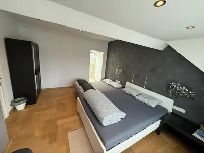 a bedroom with a bed with two pillows on it at The Beautiful White House in Kortenberg