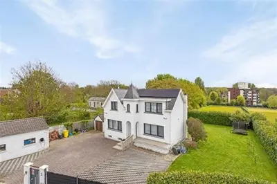 an aerial view of a white house with a yard at The Beautiful White House in Kortenberg
