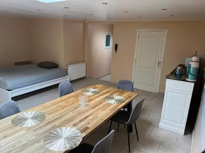 a room with a table and chairs and a bed at Bruxelles IN in Brussels