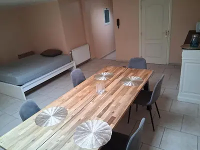 a dining room with a wooden table and chairs at Bruxelles IN in Brussels