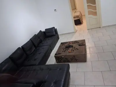 a black leather couch sitting in a living room at Bruxelles IN in Brussels