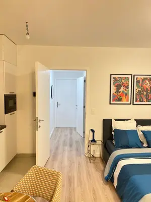 a bedroom with a bed and a door to a hallway at Love-room-brussels in Brussels