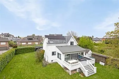 a large white house on a green yard at The Beautiful White Villa in Kortenberg