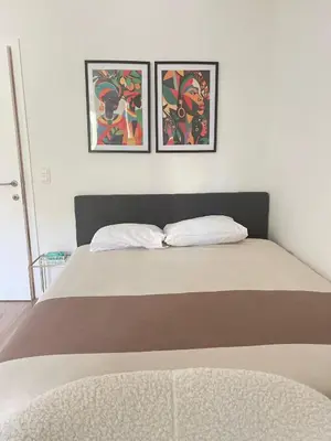 a bedroom with two pictures on the wall and a bed at Brussels City Chambers in Brussels