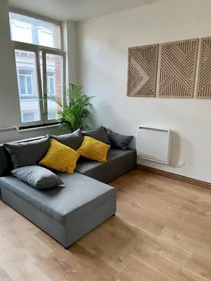 a living room with a couch and a window at Bel appartement proche de tout in Brussels