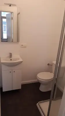 a bathroom with a toilet and a sink and a mirror at Bel appartement proche de tout in Brussels