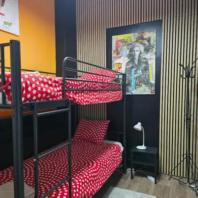 a bedroom with two bunk beds with red and white pillows at Balacobaco in Brussels