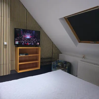 a bedroom with a bed and a flat screen tv at Balacobaco in Brussels