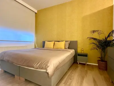 a bedroom with a bed and a potted plant at Luxury Suites Royal by Rikas Hotels in Antwerp