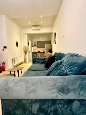 a living room with two blue couches and a table at Luxury Suites Royal by Rikas Hotels in Antwerp