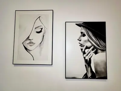 two framed pictures of a woman talking on a cell phone at Luxury Suites Royal by Rikas Hotels in Antwerp