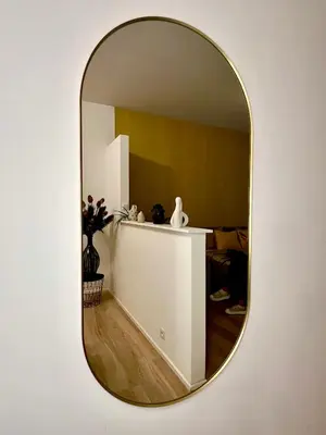 a mirror hanging on a wall with a room at Luxury Suites Royal by Rikas Hotels in Antwerp